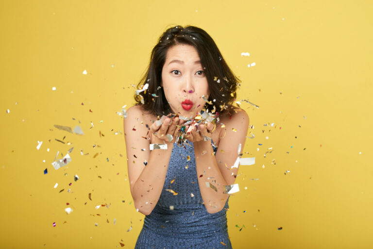 a person blowing confetti