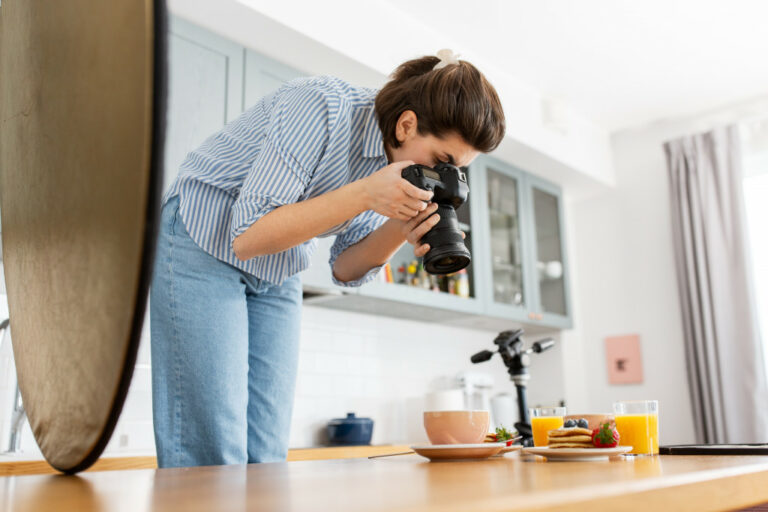 A photographer taking picture of a cup