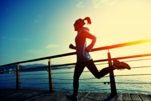 woman jogging along bay area